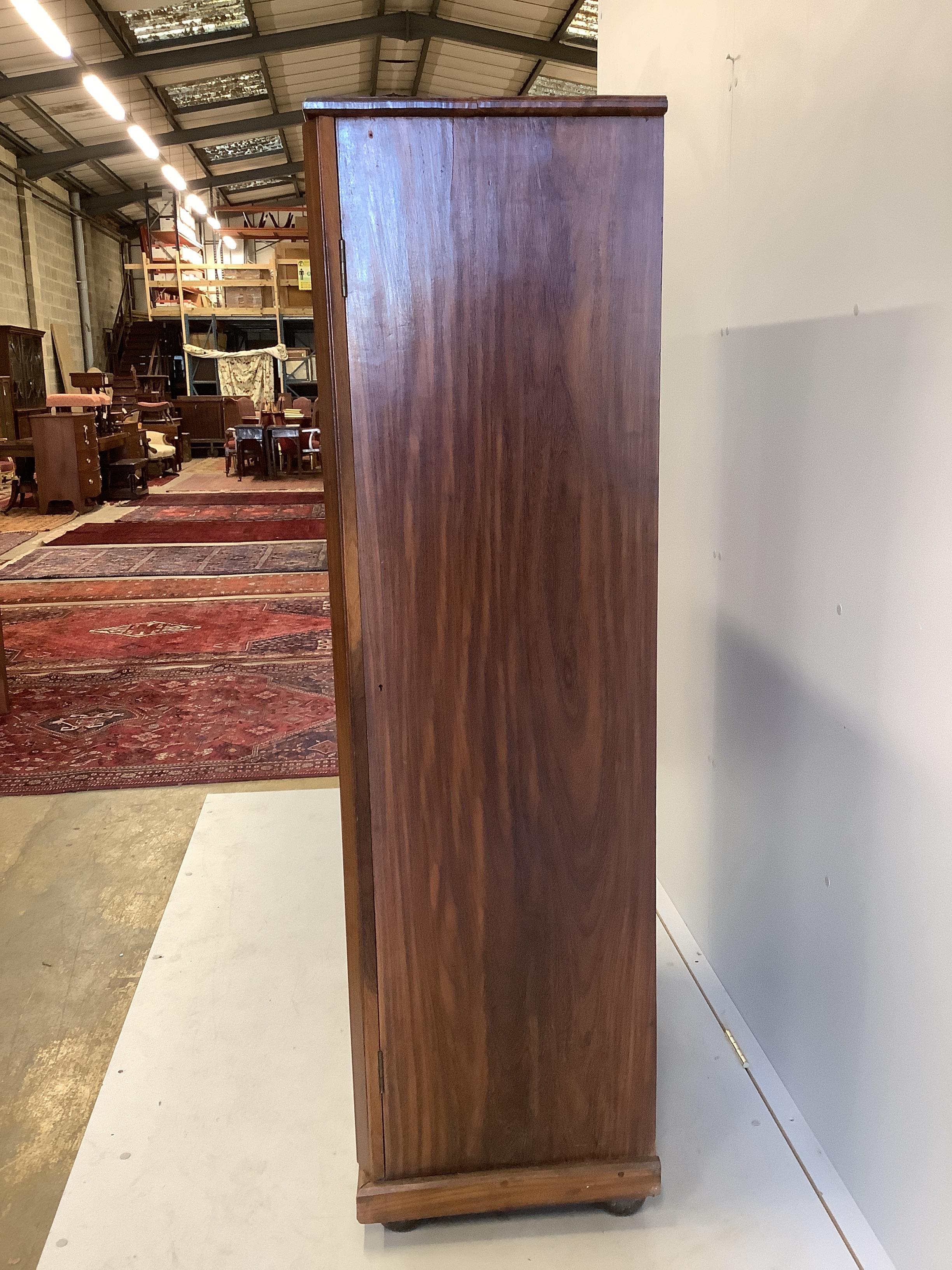 A mid century Sri Lankan mahogany collector's cabinet fitted sixteen graduated drawers, back panel stamped Don Andris, Cabinet Makers, Colombo, width 80cm, depth 44cm, height 156cm